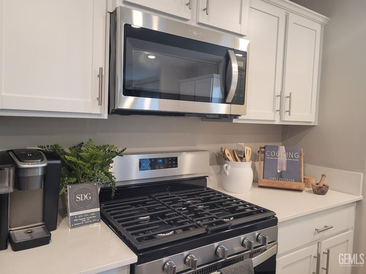 Undisclosed Address Bakersfield, CA 93313 - Photo 6 of 25 a kitchen with a stove and a microwave