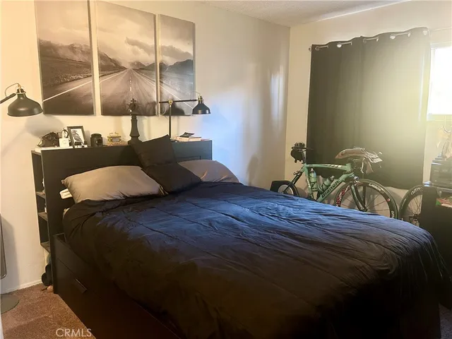 a bedroom with a bed and window