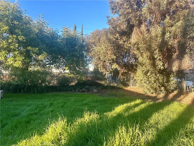 a backyard of a house with lots of green space and garden