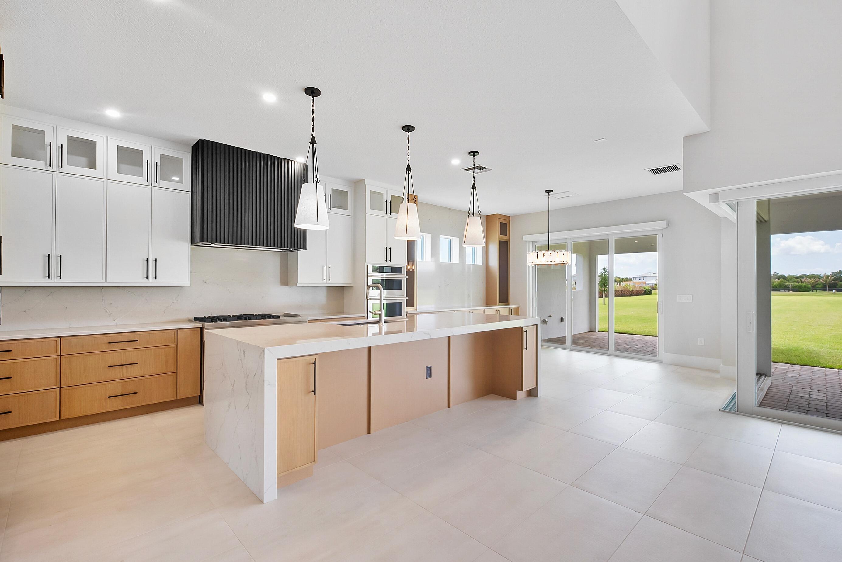 20060 Southeast Bridgewater Drive Jupiter, FL 33458 - Photo 22 of 68 a large kitchen with a large counter top cabinets and stainless steel appliances