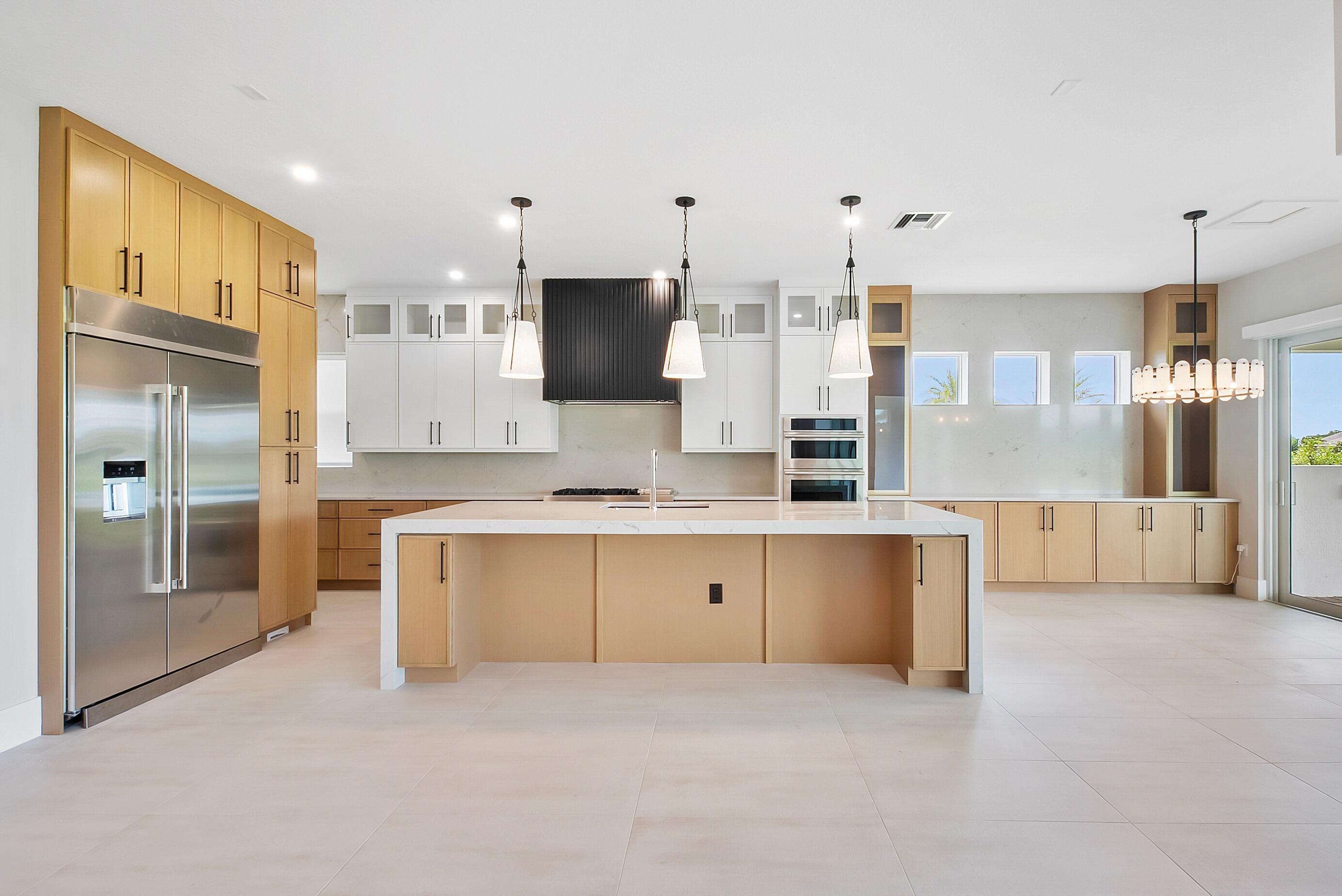 20060 Southeast Bridgewater Drive Jupiter, FL 33458 - Photo 23 of 68 a large white kitchen with a refrigerator a sink and a stove