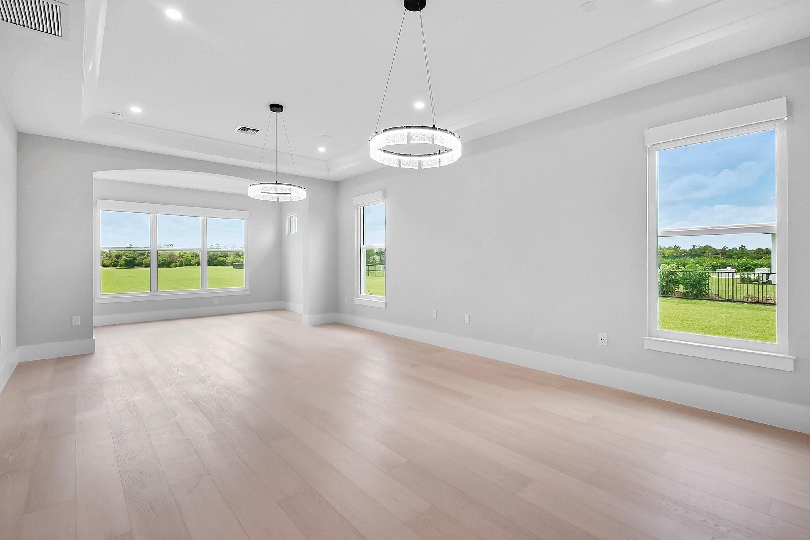 20060 Southeast Bridgewater Drive Jupiter, FL 33458 - Photo 24 of 68 a view of an empty room with a window and wooden floor