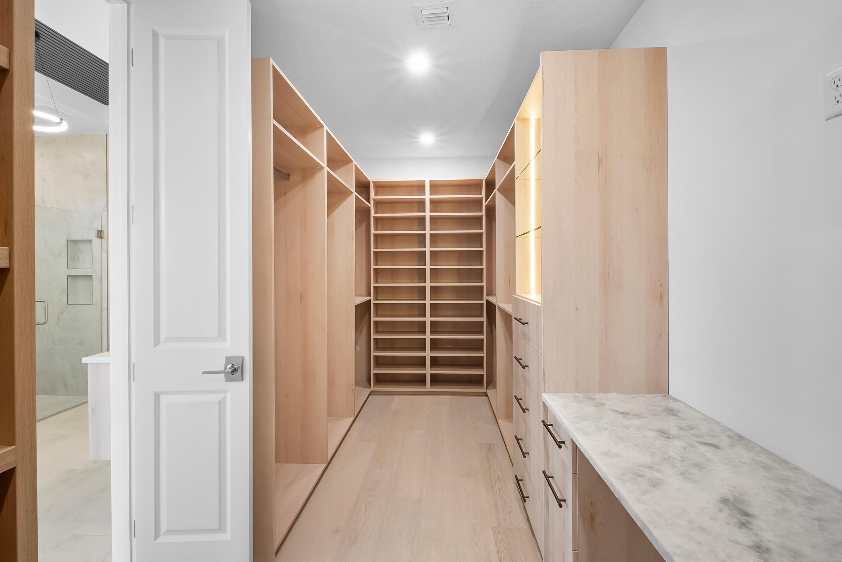 20060 Southeast Bridgewater Drive Jupiter, FL 33458 - Photo 27 of 68 a view of walk in closet with clothes and shoes