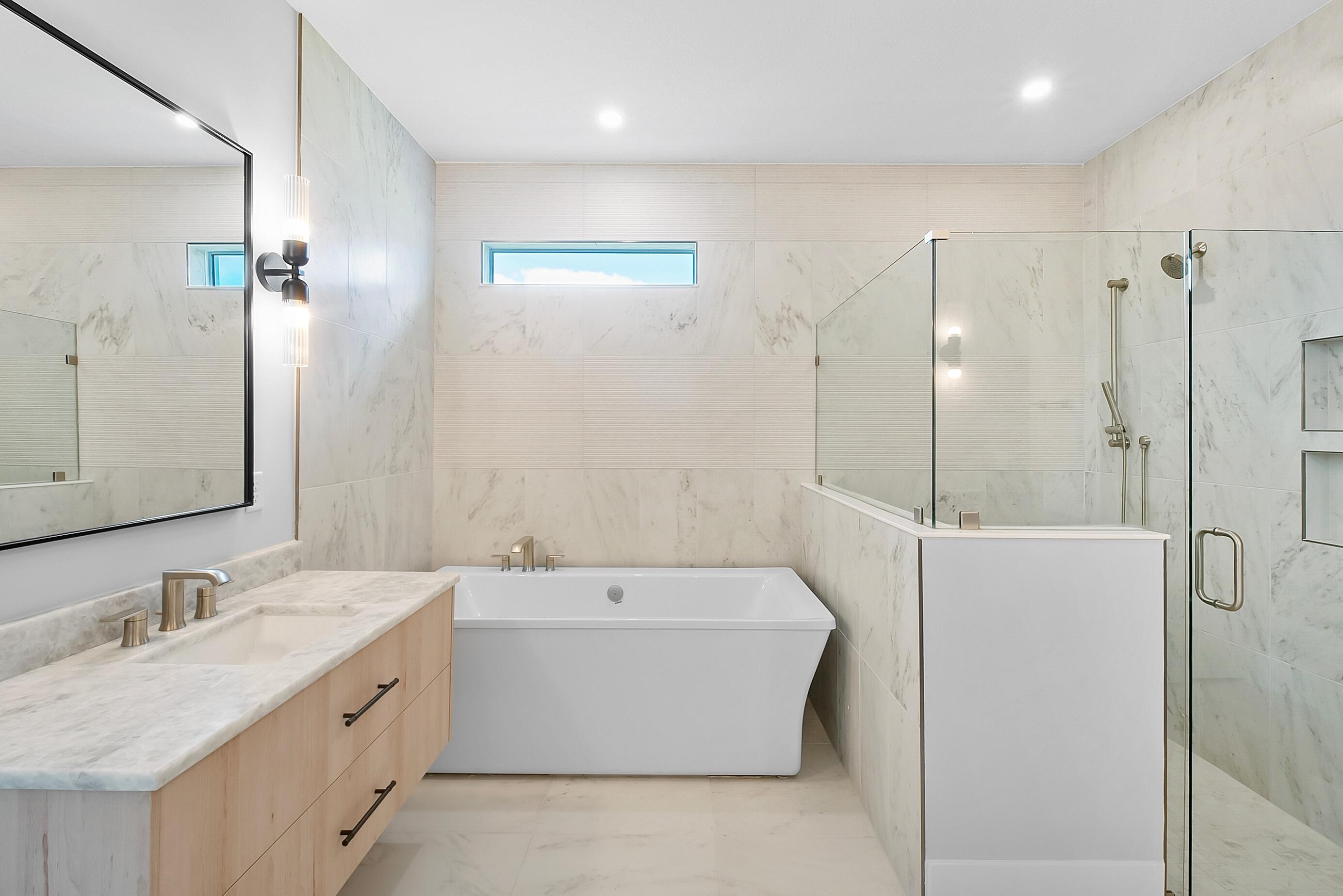 20060 Southeast Bridgewater Drive Jupiter, FL 33458 - Photo 29 of 68 a bathroom with a tub sink double and mirror