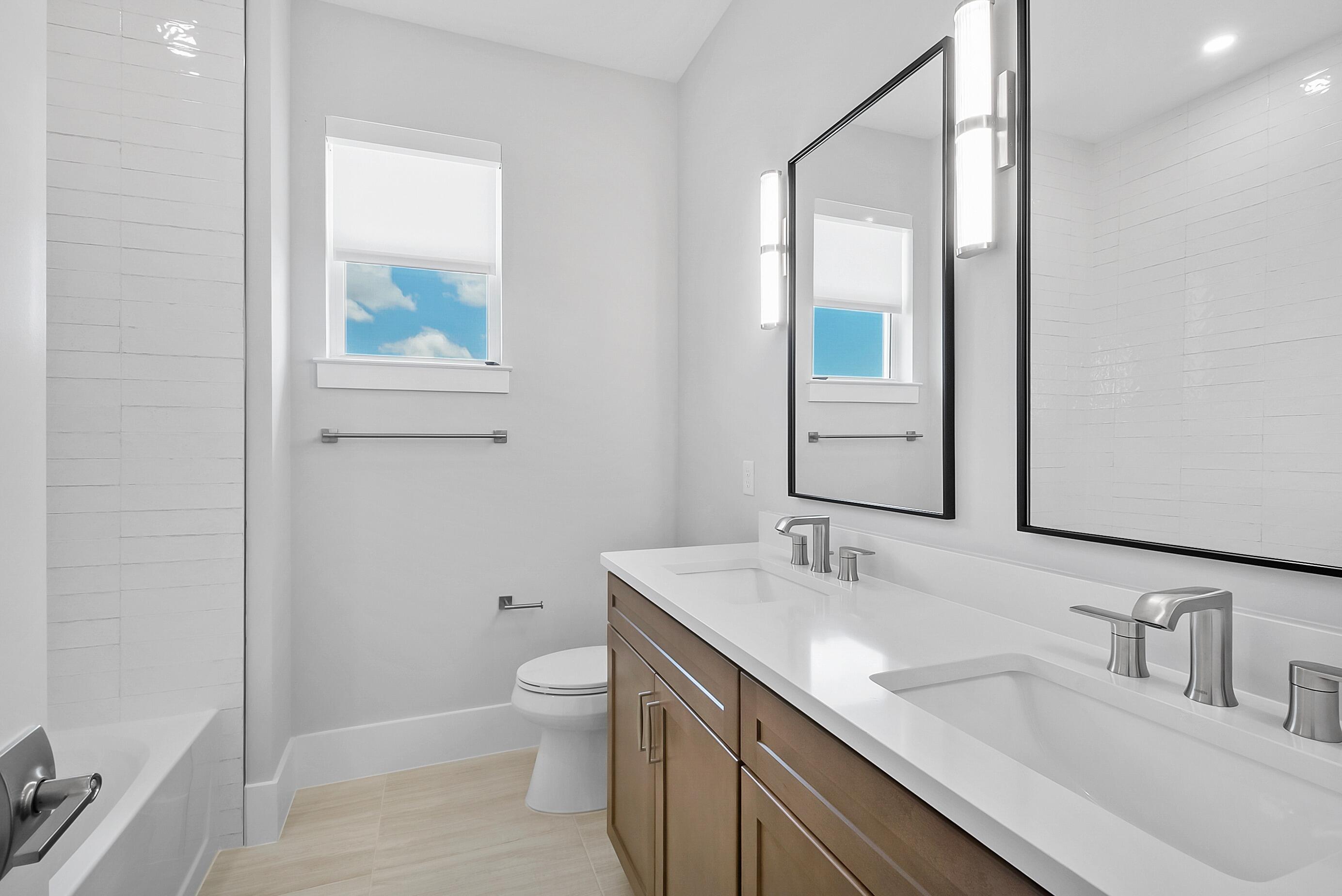 20060 Southeast Bridgewater Drive Jupiter, FL 33458 - Photo 37 of 68 a bathroom with a sink a toilet and a mirror