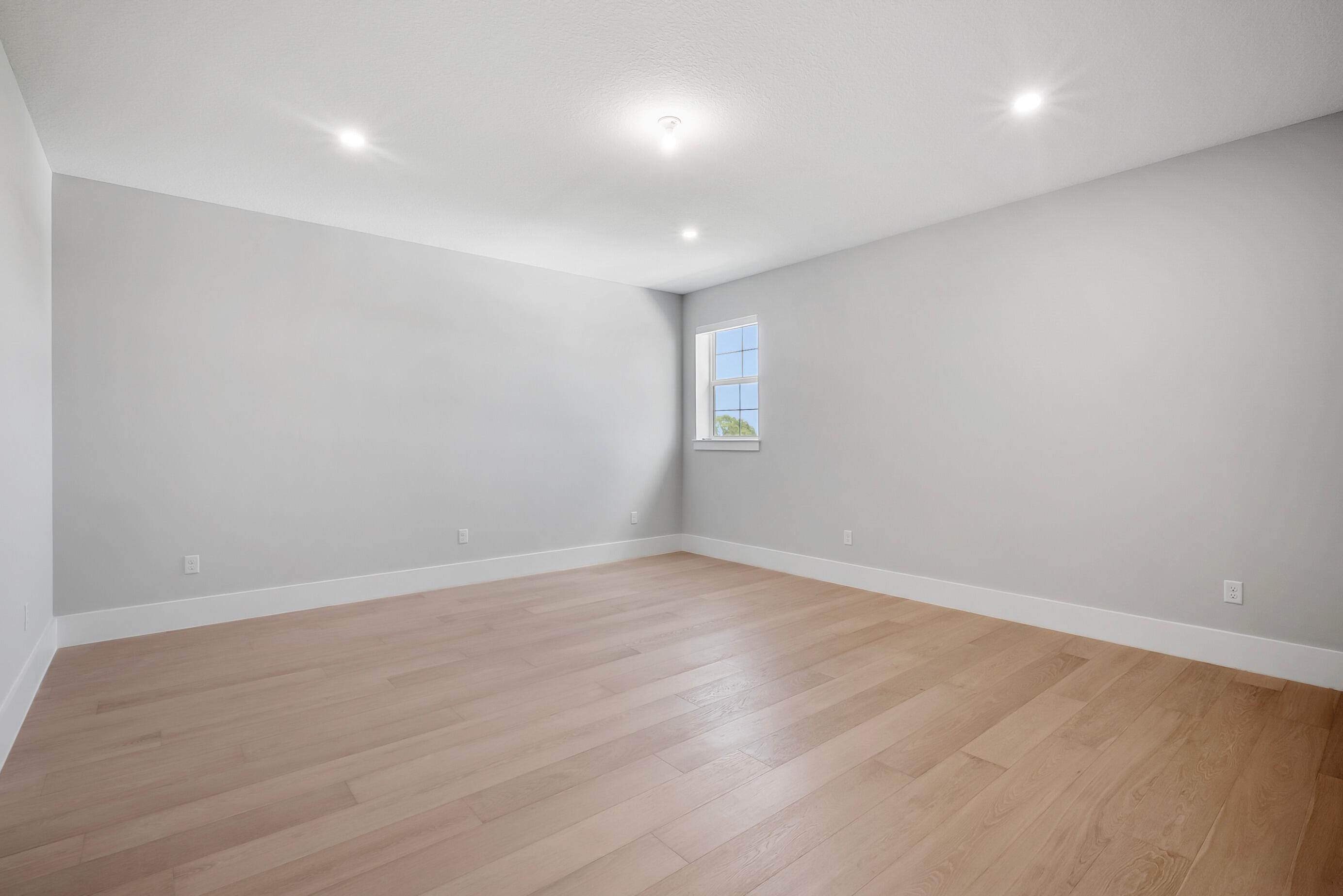 20060 Southeast Bridgewater Drive Jupiter, FL 33458 - Photo 39 of 68 an empty room with wooden floor and windows