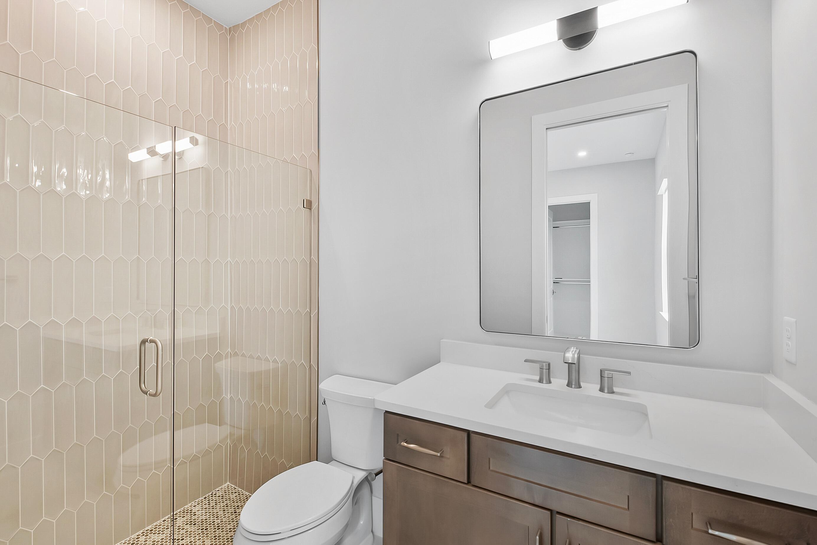 20060 Southeast Bridgewater Drive Jupiter, FL 33458 - Photo 42 of 68 a bathroom with a sink a toilet and shower