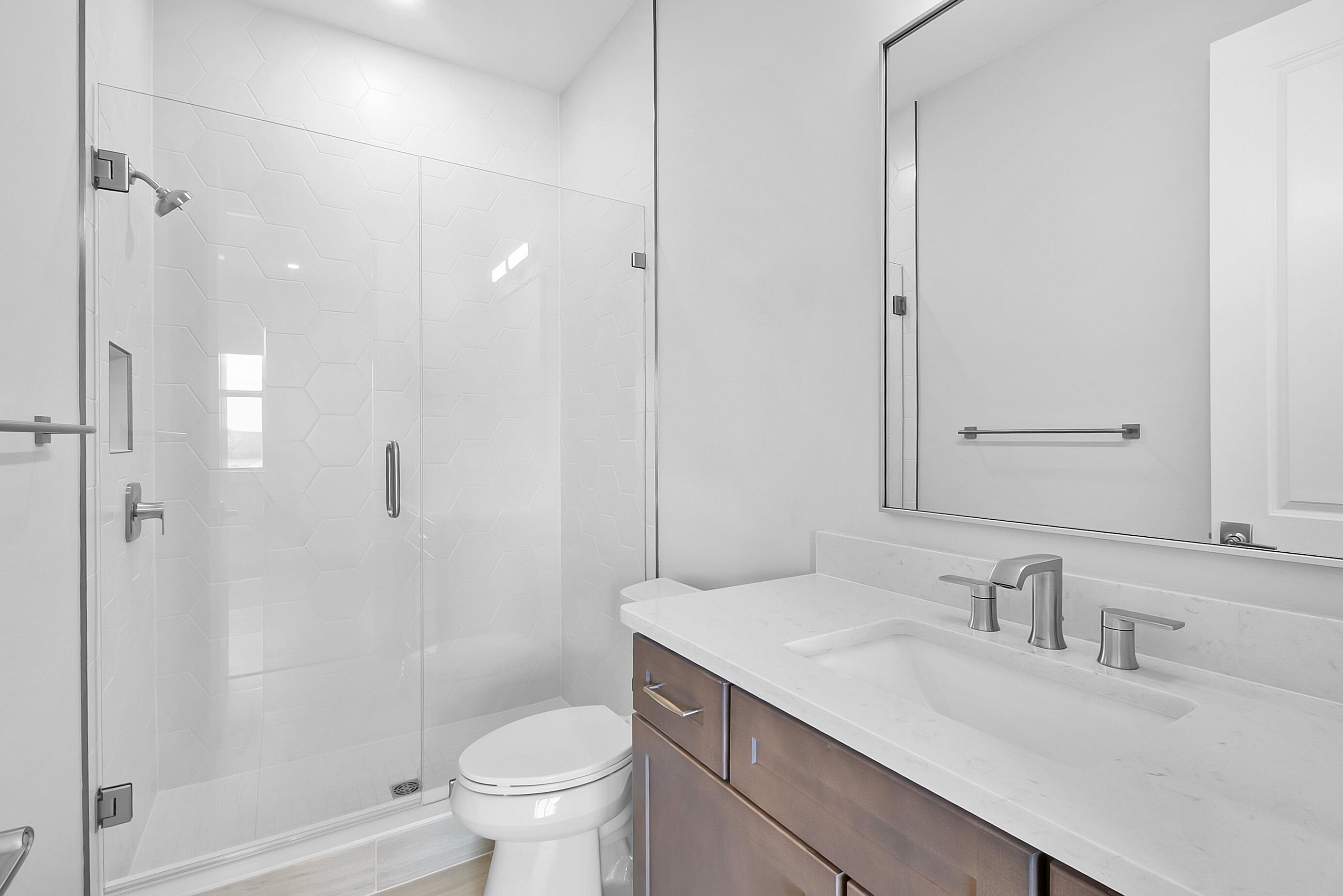 20060 Southeast Bridgewater Drive Jupiter, FL 33458 - Photo 44 of 68 a bathroom with a granite countertop sink a toilet and shower