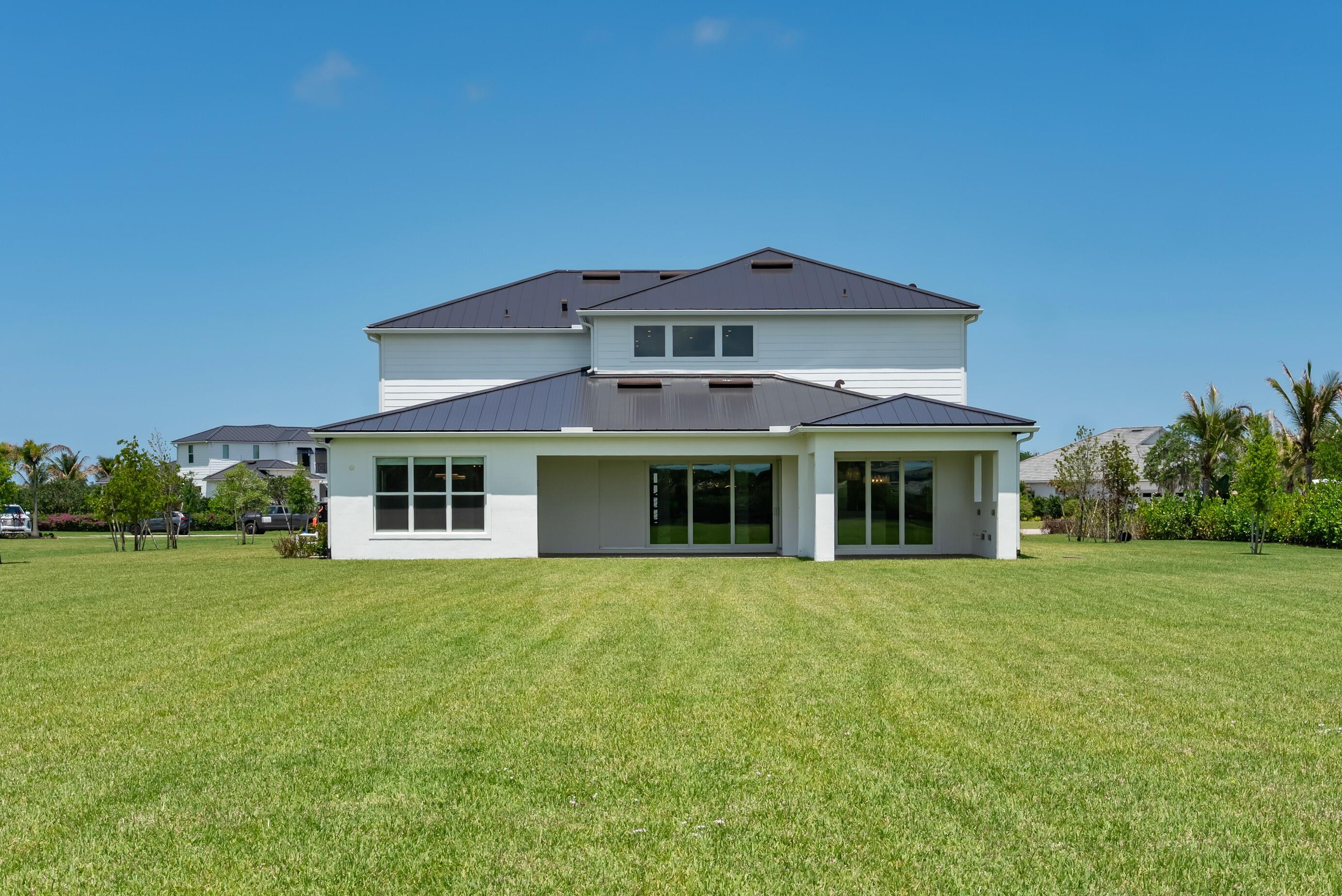 20060 Southeast Bridgewater Drive Jupiter, FL 33458 - Photo 50 of 68 a front view of a house with a garden