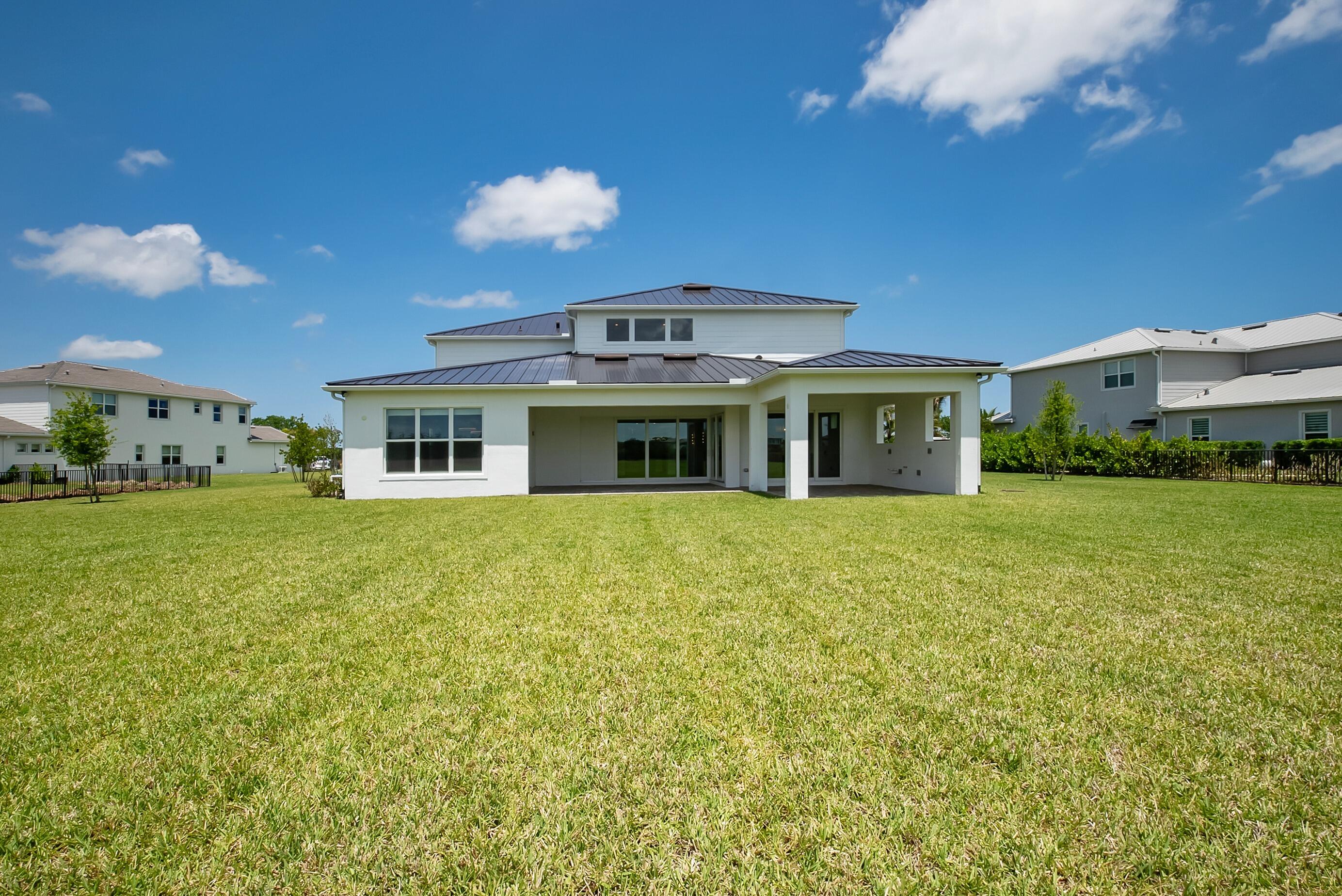 20060 Southeast Bridgewater Drive Jupiter, FL 33458 - Photo 51 of 68 a front view of a house with garden