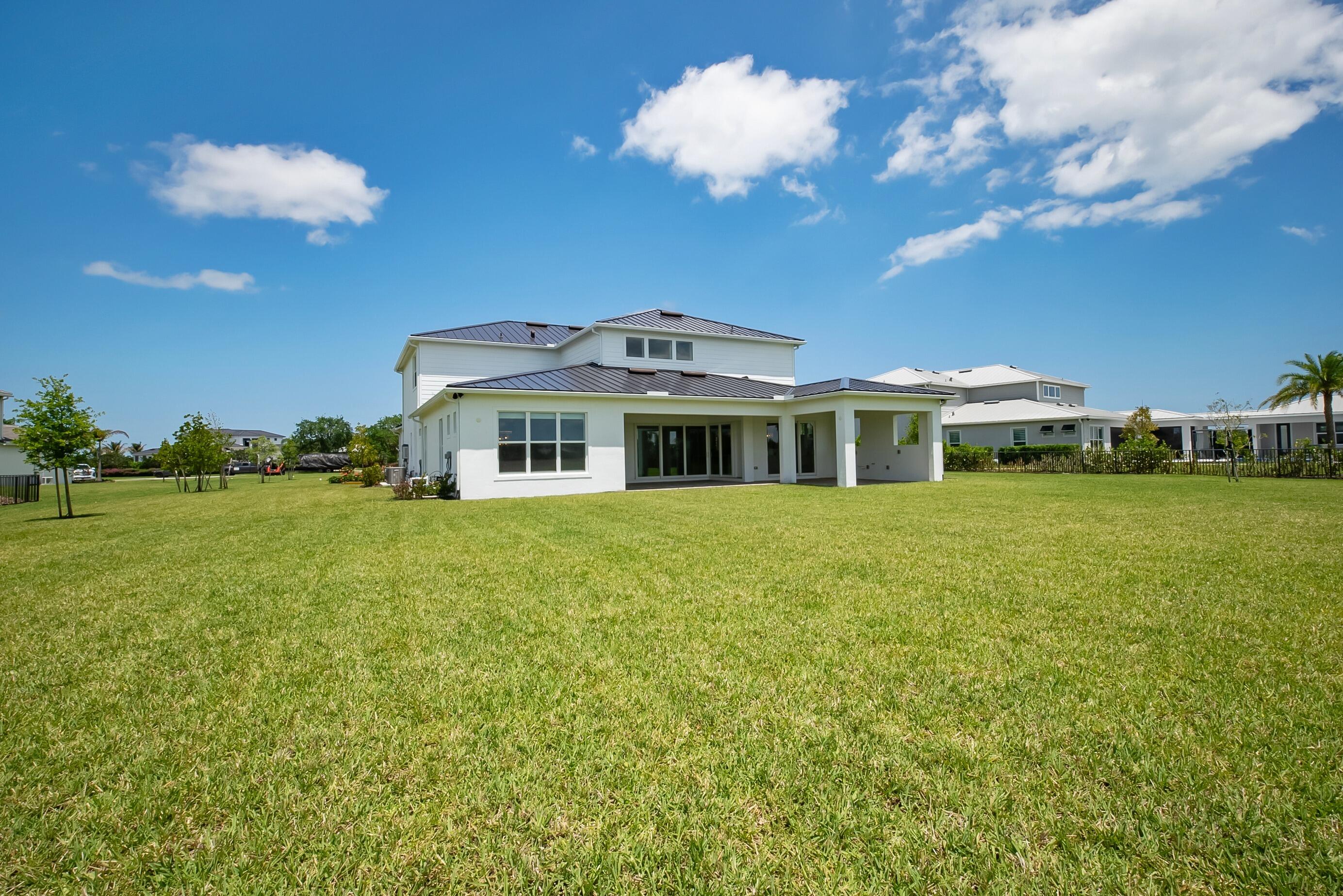 20060 Southeast Bridgewater Drive Jupiter, FL 33458 - Photo 52 of 68 a front view of a house with garden