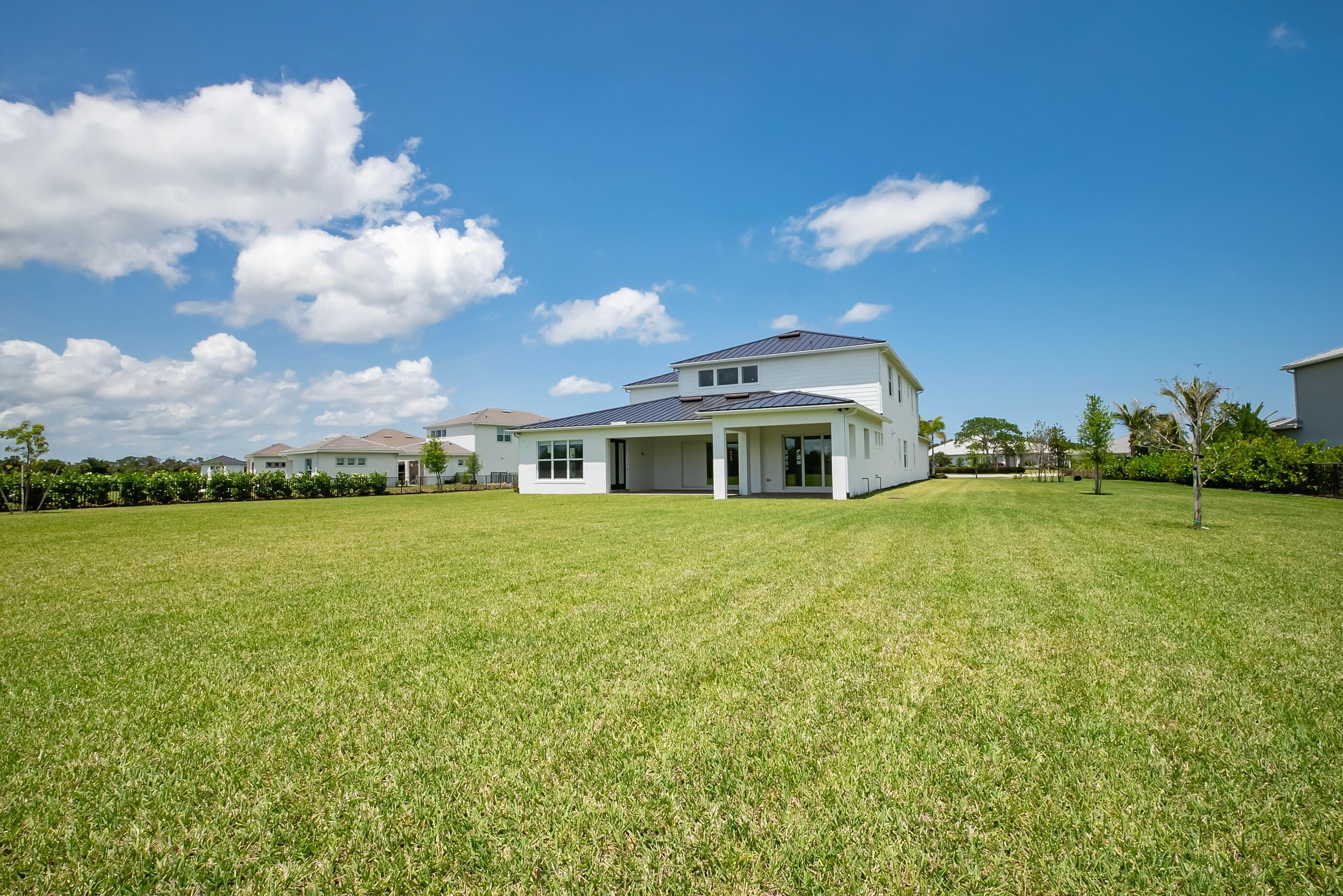 20060 Southeast Bridgewater Drive Jupiter, FL 33458 - Photo 53 of 68 a front view of a house with a yard