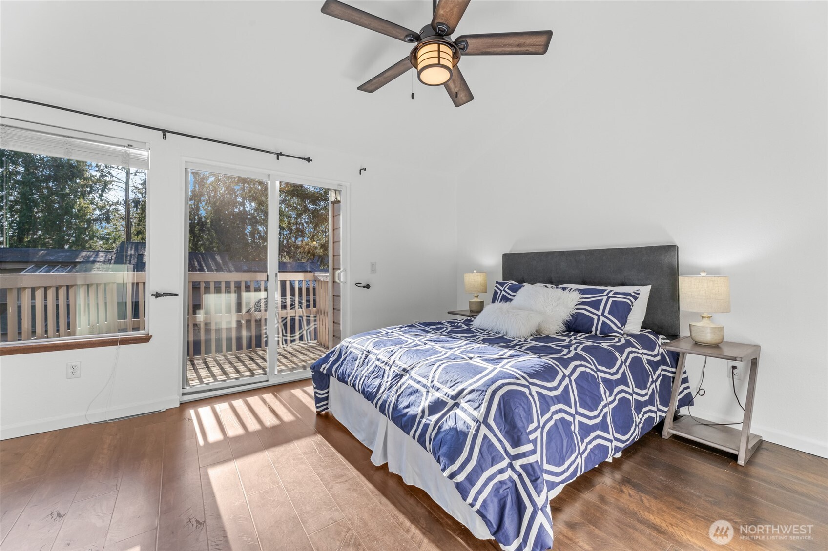 1555 Union Avenue Northeast, Unit 39 Renton, WA 98059 - Photo 13 of 19 a bedroom with a bed and wooden floor