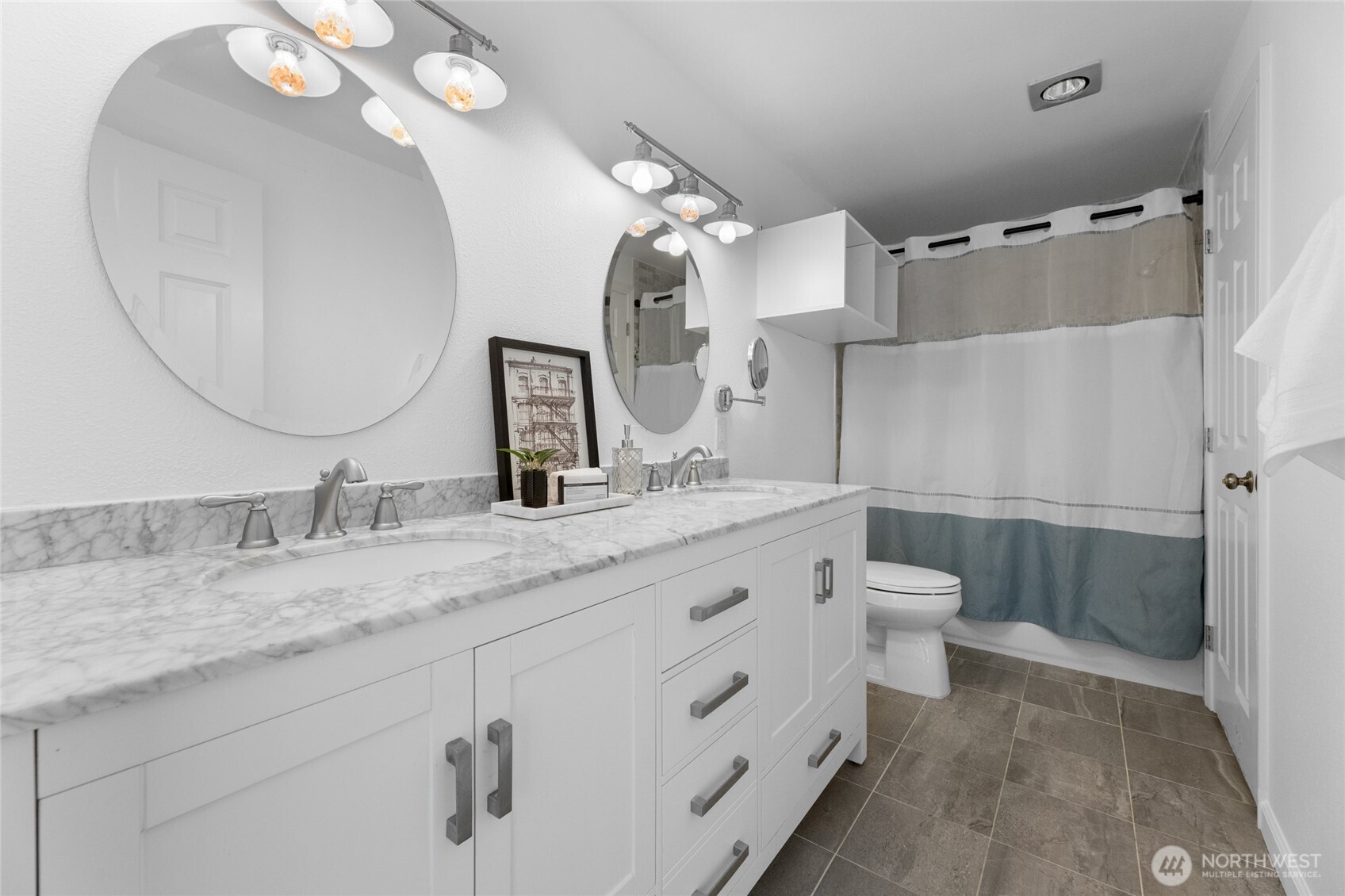 1555 Union Avenue Northeast, Unit 39 Renton, WA 98059 - Photo 16 of 19 a bathroom with a granite countertop sink a toilet and a mirror