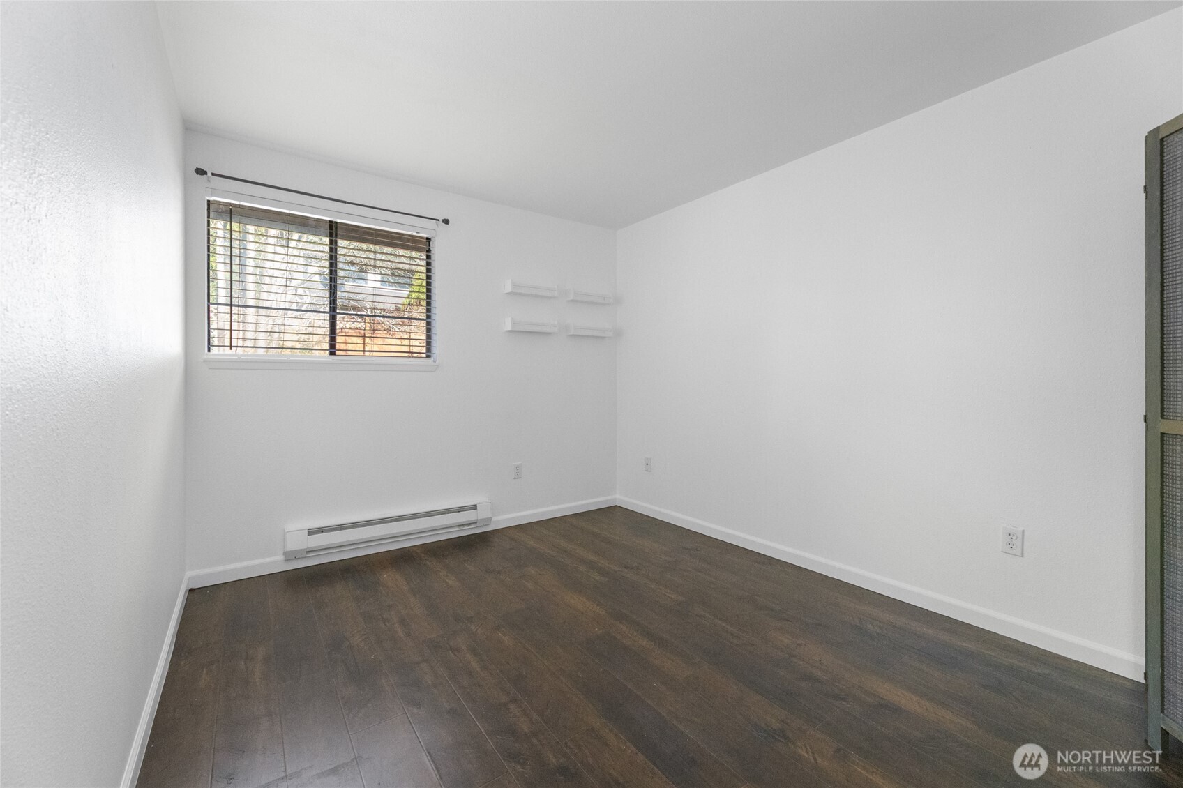 1555 Union Avenue Northeast, Unit 39 Renton, WA 98059 - Photo 18 of 19 an empty room with wooden floor and windows
