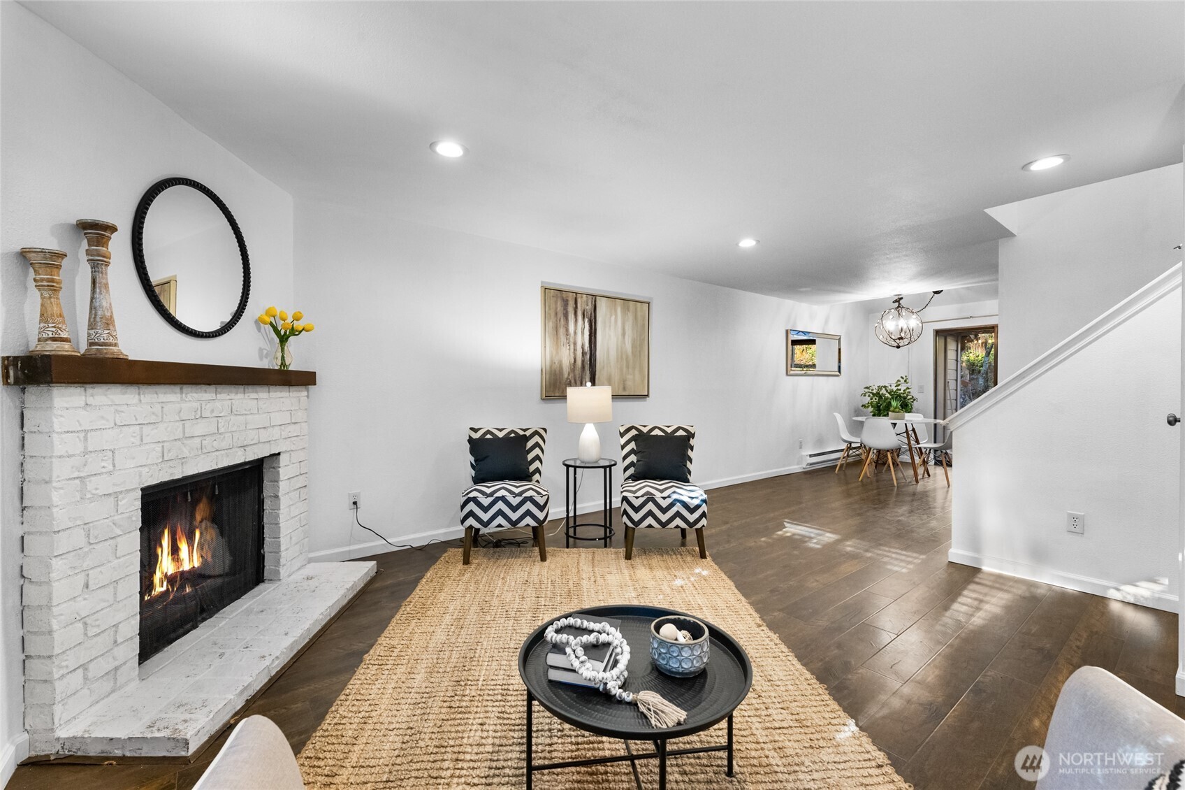 1555 Union Avenue Northeast, Unit 39 Renton, WA 98059 - Photo 4 of 19 a living room with furniture a fireplace and a table