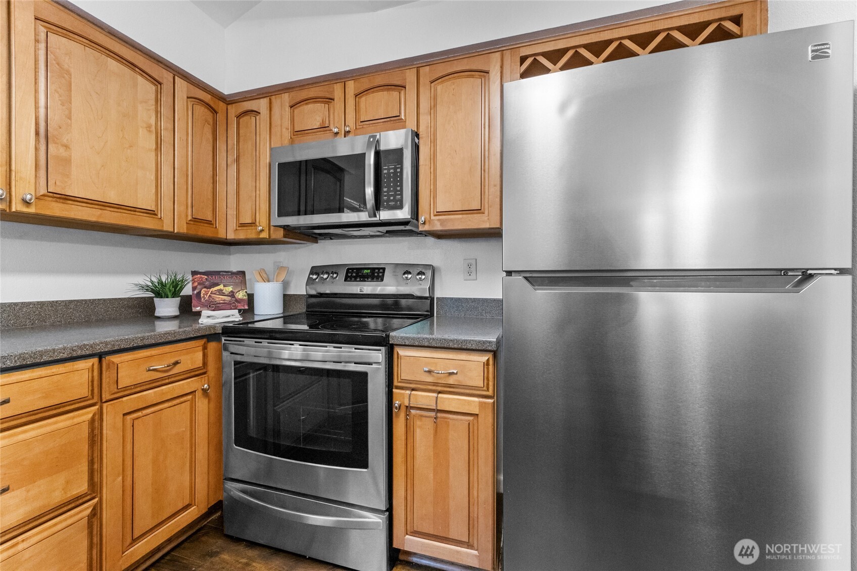 1555 Union Avenue Northeast, Unit 39 Renton, WA 98059 - Photo 9 of 19 a kitchen with stainless steel appliances granite countertop a refrigerator a microwave oven a sink and dishwasher