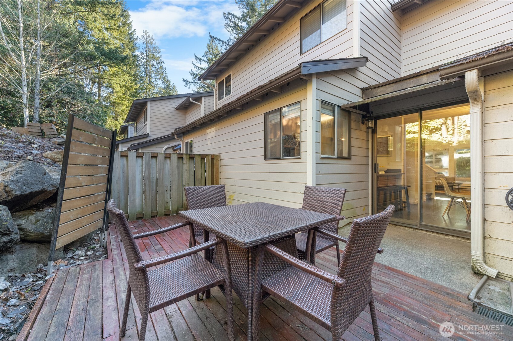 1555 Union Avenue Northeast, Unit 39 Renton, WA 98059 - Photo 10 of 19 a view of a patio with table and chairs with wooden floor and fence
