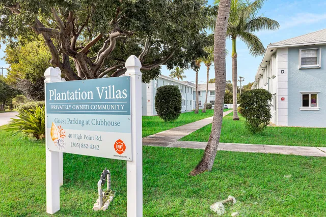 a view of a street sign under a large tree