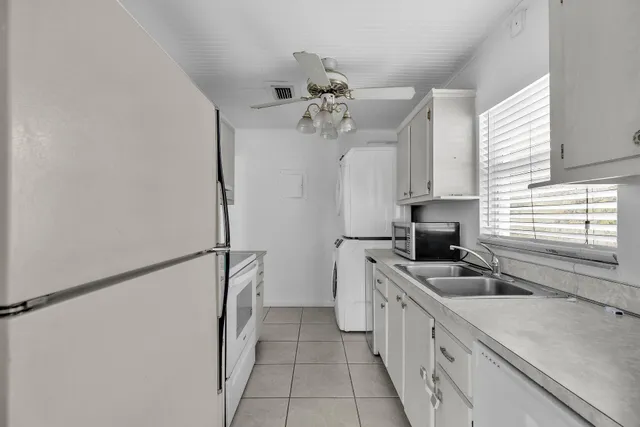 a kitchen with stainless steel appliances a sink stove and refrigerator