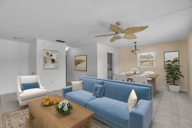 a living room with furniture potted plant and a chandelier