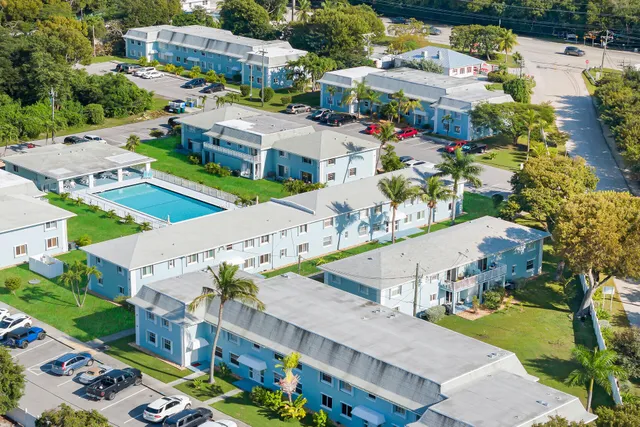 an aerial view of residential houses with outdoor space and street view