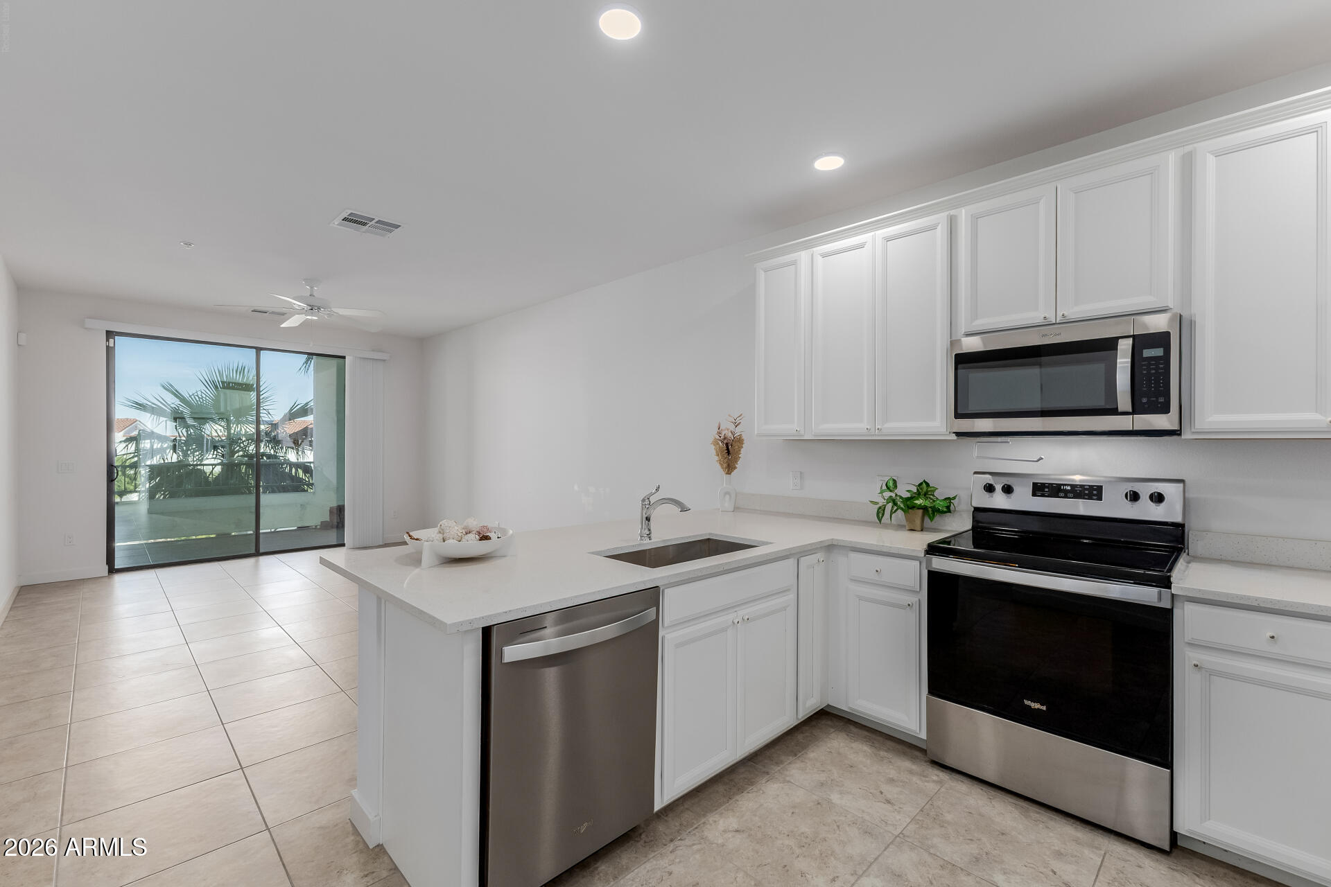 a kitchen with a sink stove and microwave