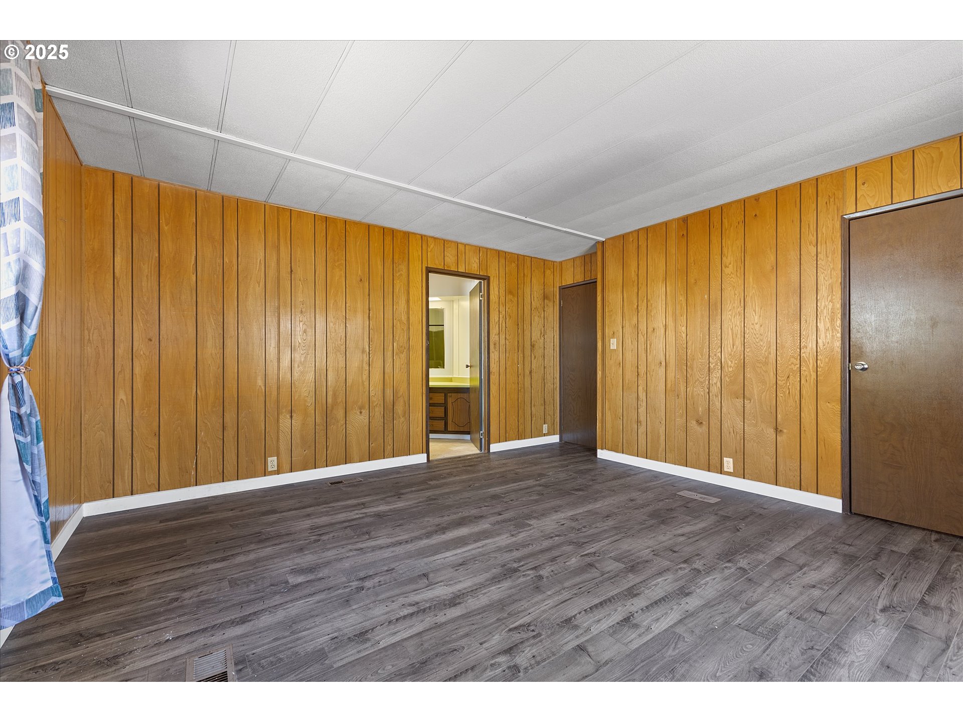 2902 East 2nd Street, Unit 110 Newberg, OR 97132 - Photo 12 of 29 a view of an empty room with wooden floor