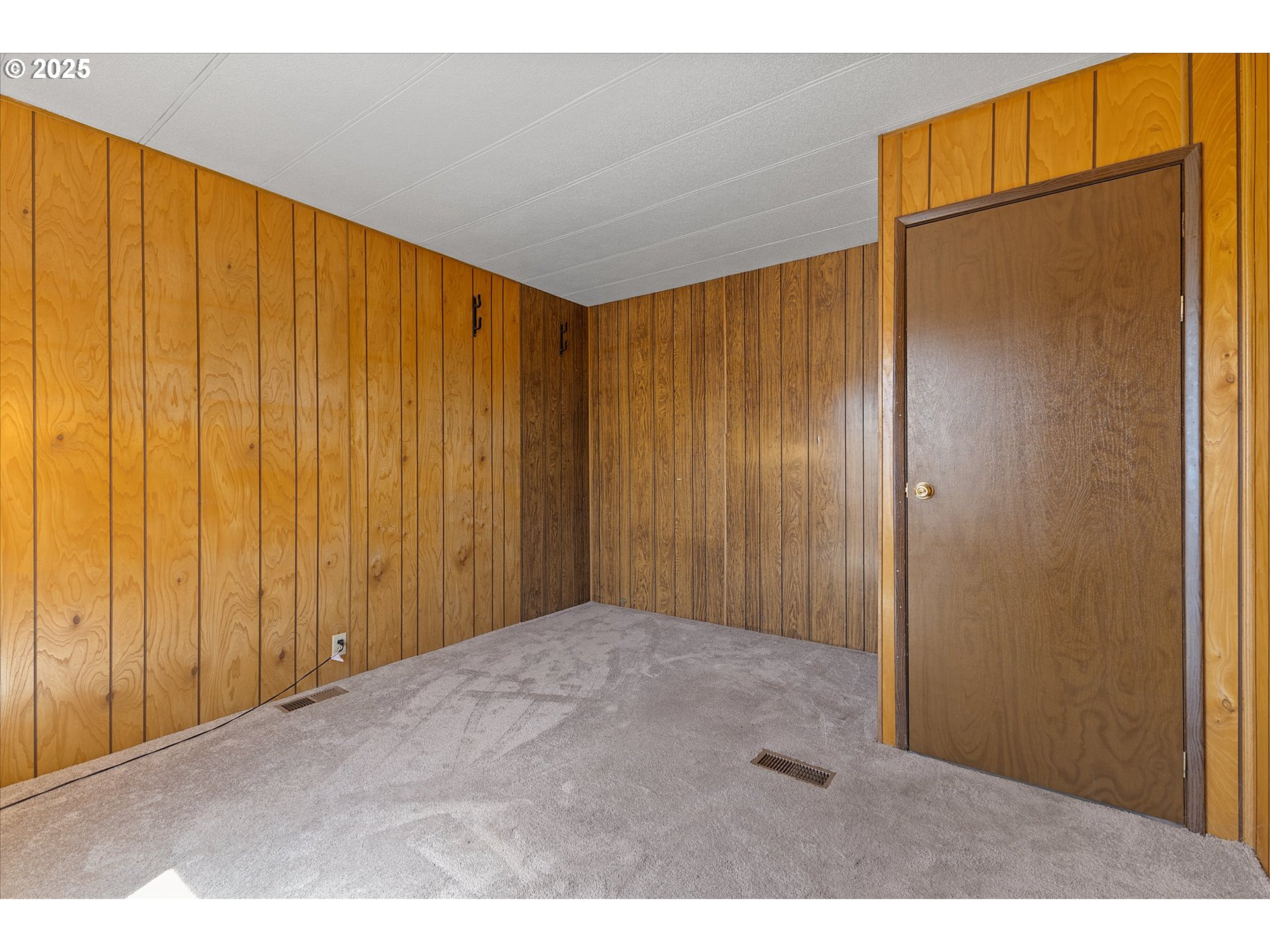 2902 East 2nd Street, Unit 110 Newberg, OR 97132 - Photo 17 of 29 a view of an empty room with wooden floor
