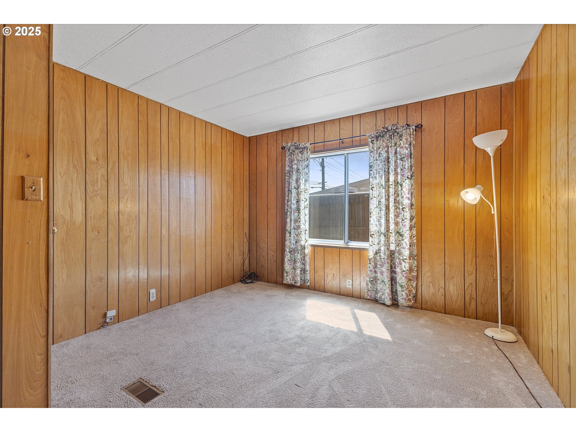 2902 East 2nd Street, Unit 110 Newberg, OR 97132 - Photo 18 of 29 a view of an empty room with a fireplace and a window