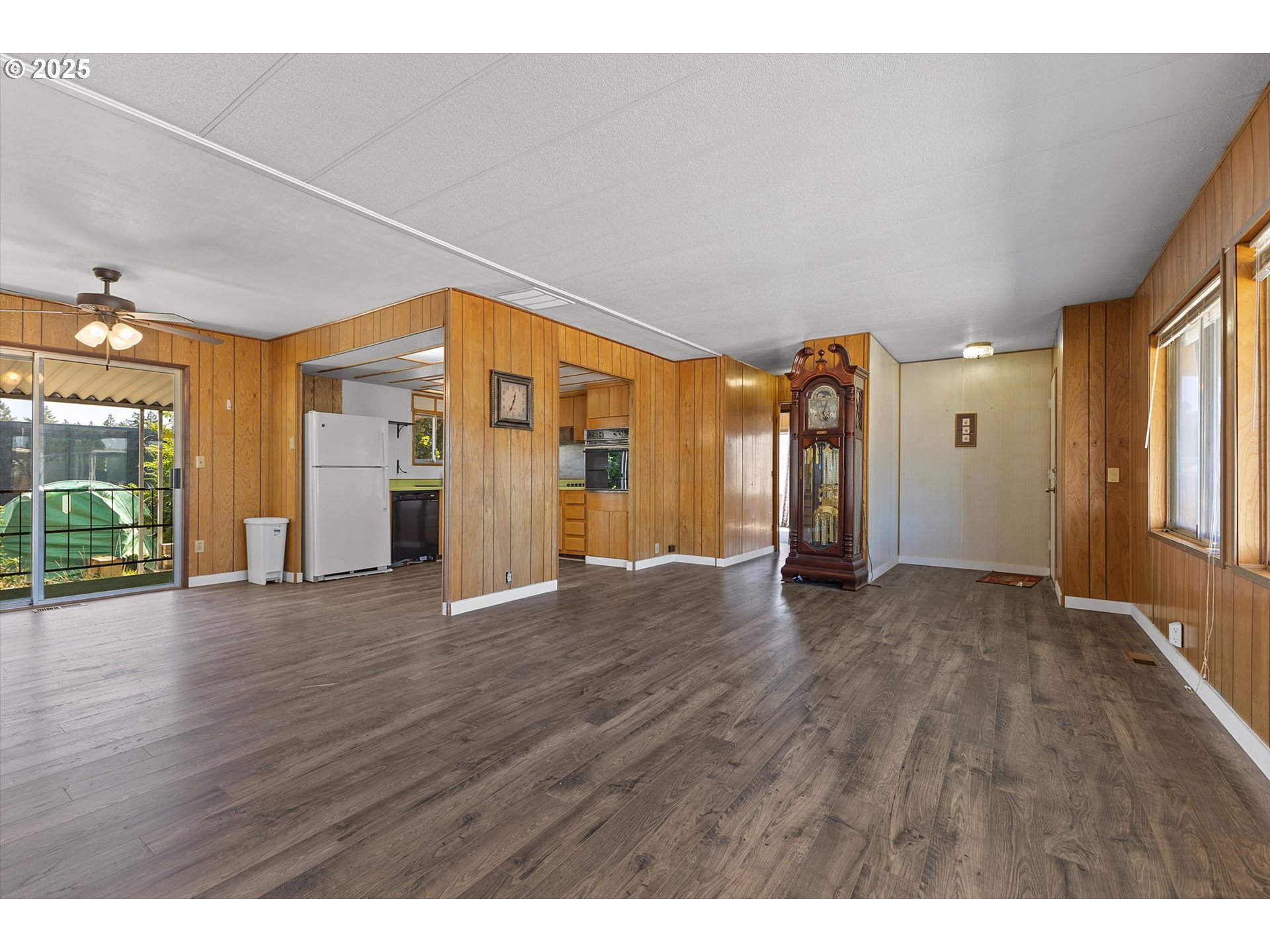 2902 East 2nd Street, Unit 110 Newberg, OR 97132 - Photo 4 of 29 a view of an empty room with wooden floor and a window