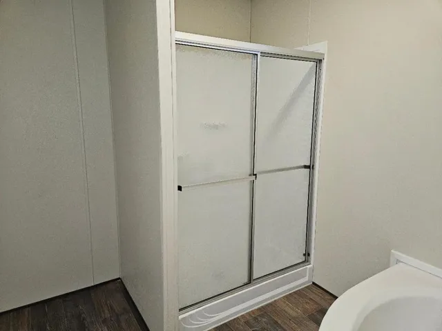 a view of wooden floor and windows in a room