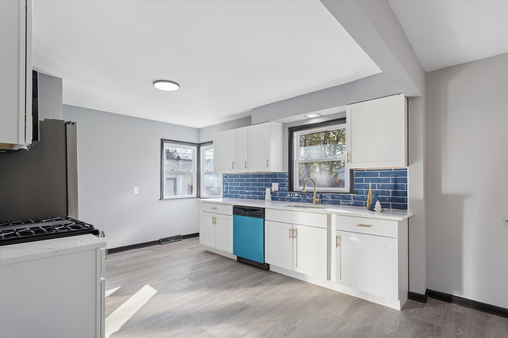 17641 Burnham Avenue Lansing, IL 60438 - Photo 6 of 26 a kitchen with stainless steel appliances granite countertop a stove and a sink
