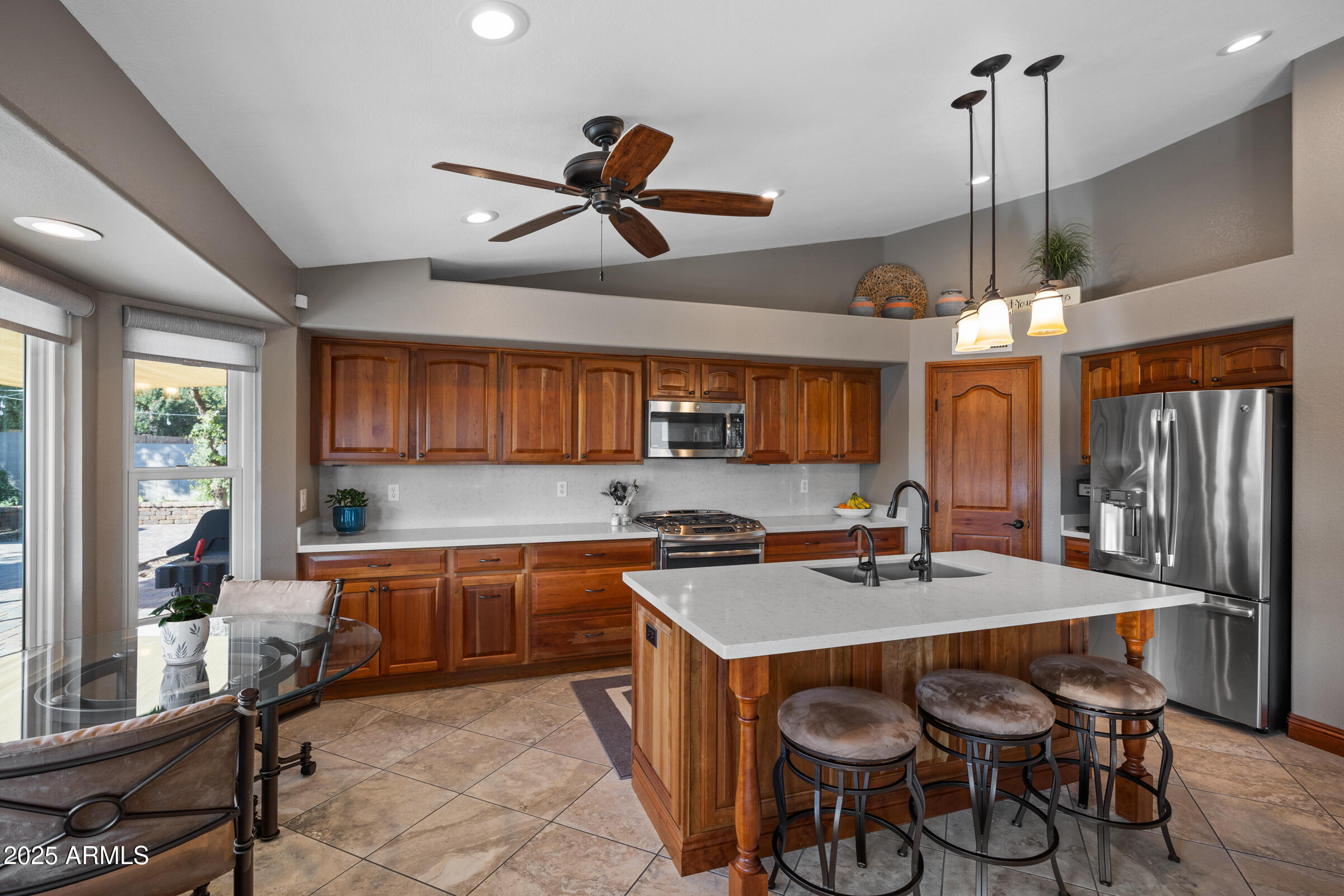 1111 West Lisa Lane Tempe, AZ 85284 - Photo 15 of 58 a kitchen with stainless steel appliances granite countertop a sink a stove and a refrigerator