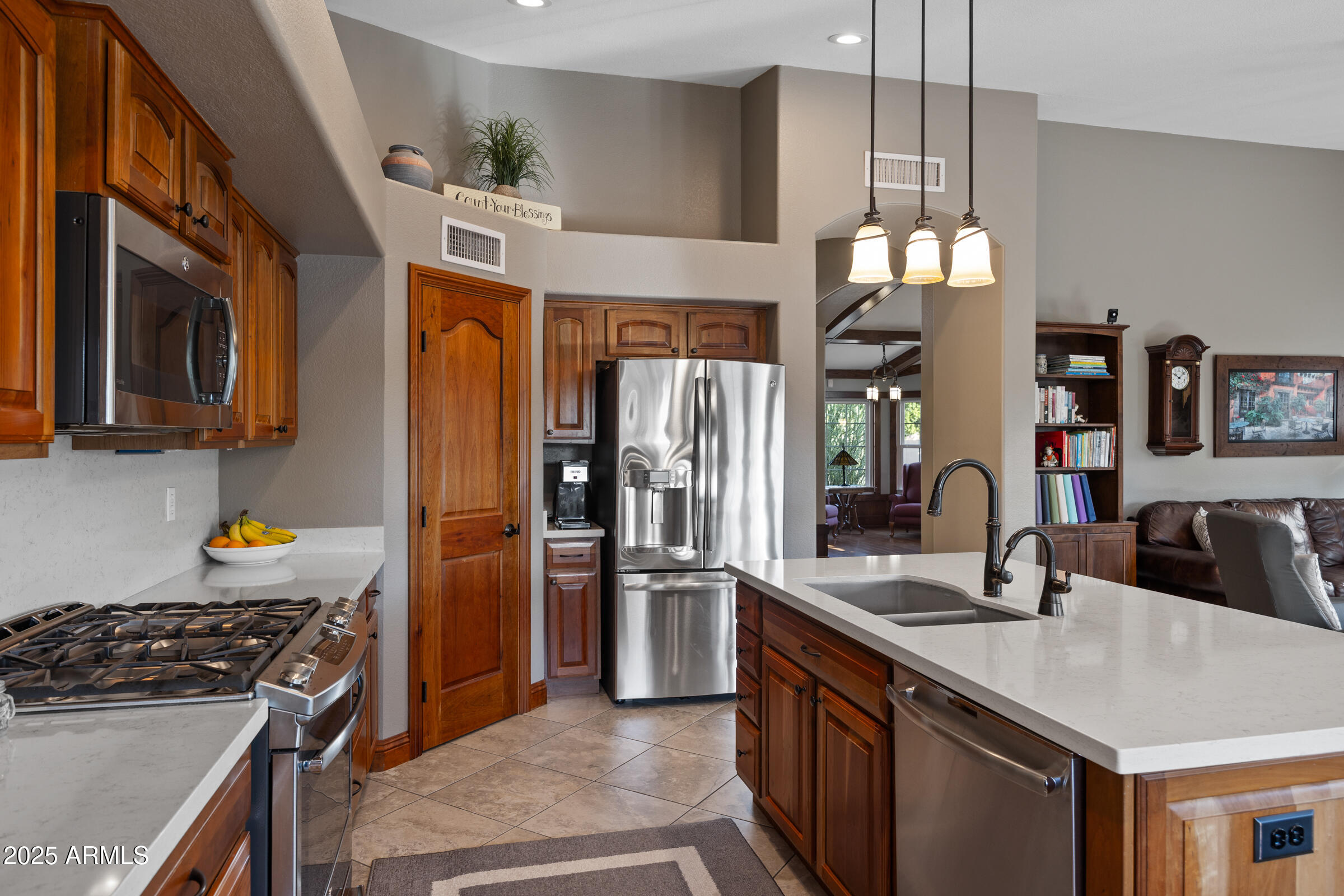 1111 West Lisa Lane Tempe, AZ 85284 - Photo 18 of 58 a kitchen with stainless steel appliances granite countertop a sink stove and refrigerator