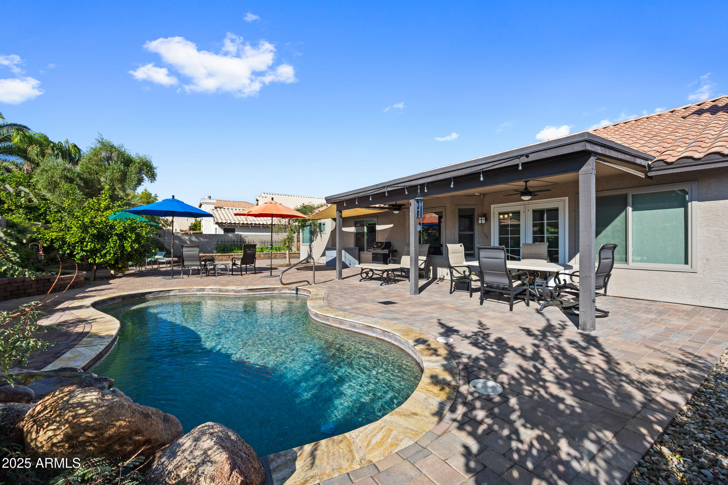 1111 West Lisa Lane Tempe, AZ 85284 - Photo 2 of 58 a view of a swimming pool with a patio and a garden