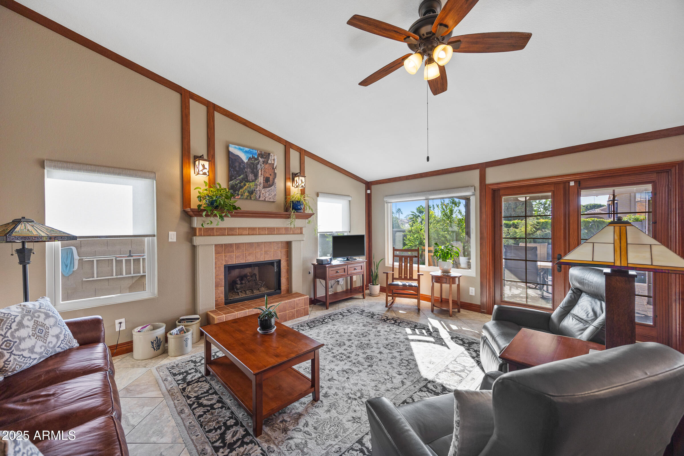 1111 West Lisa Lane Tempe, AZ 85284 - Photo 22 of 58 a living room with furniture a fireplace and a large window