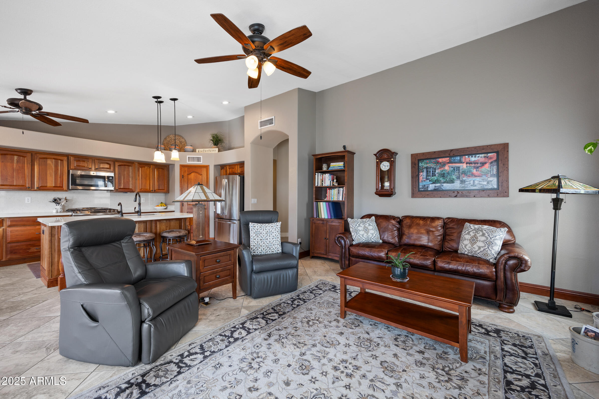 1111 West Lisa Lane Tempe, AZ 85284 - Photo 24 of 58 a living room with furniture kitchen view and a chandelier