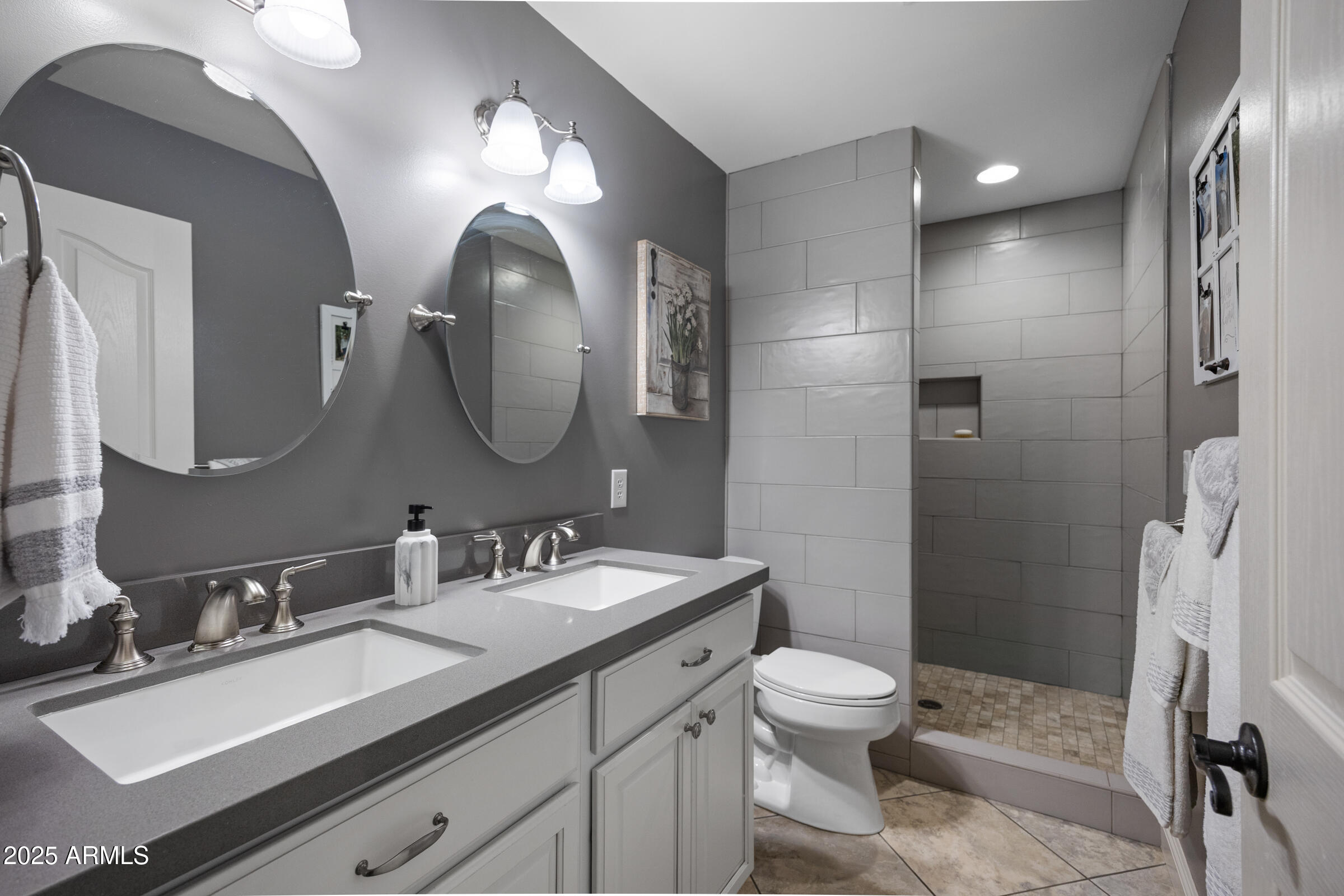1111 West Lisa Lane Tempe, AZ 85284 - Photo 28 of 58 a bathroom with a toilet sink and mirror