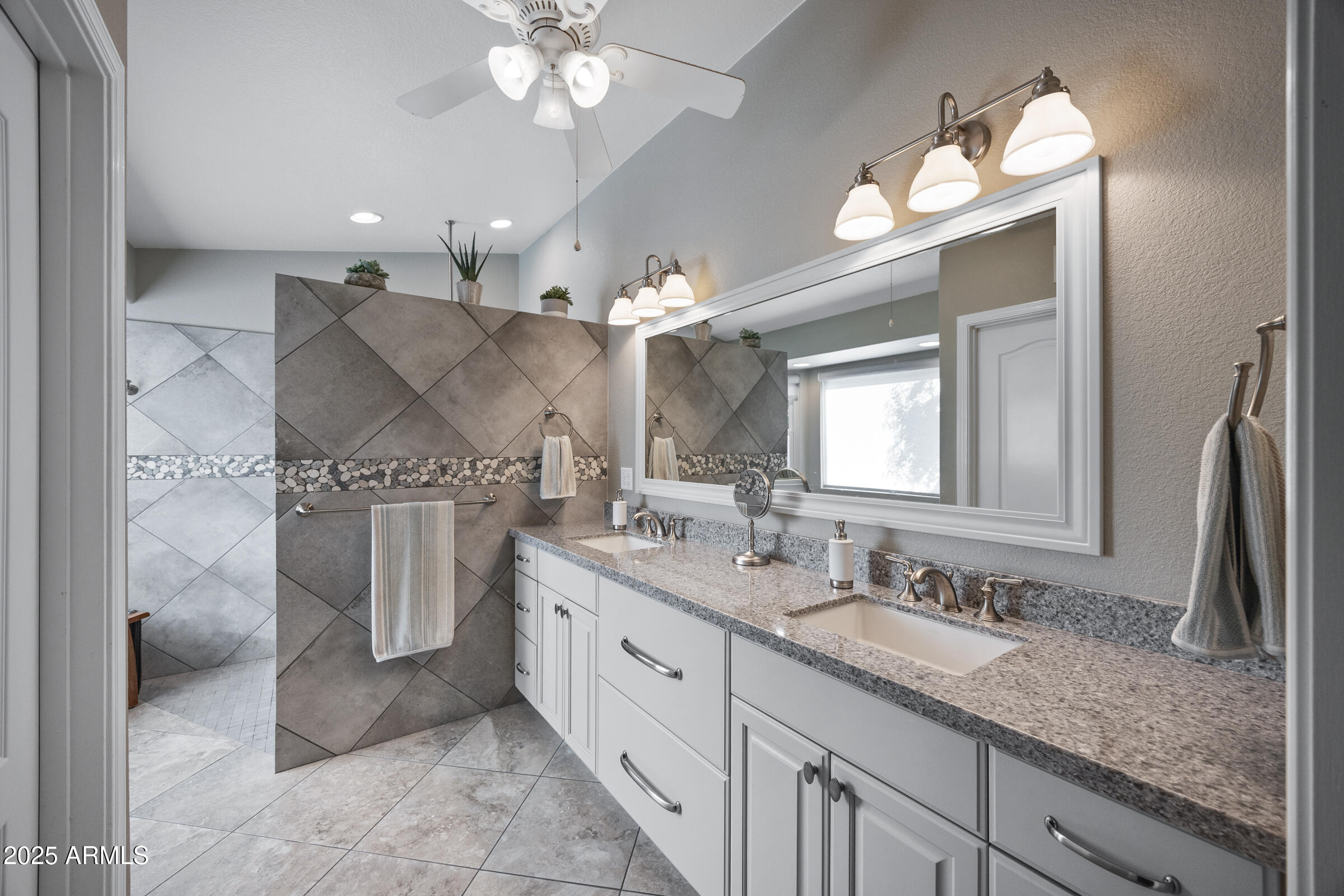 1111 West Lisa Lane Tempe, AZ 85284 - Photo 33 of 58 a spacious bathroom with a granite countertop sink a light fixture and a mirror
