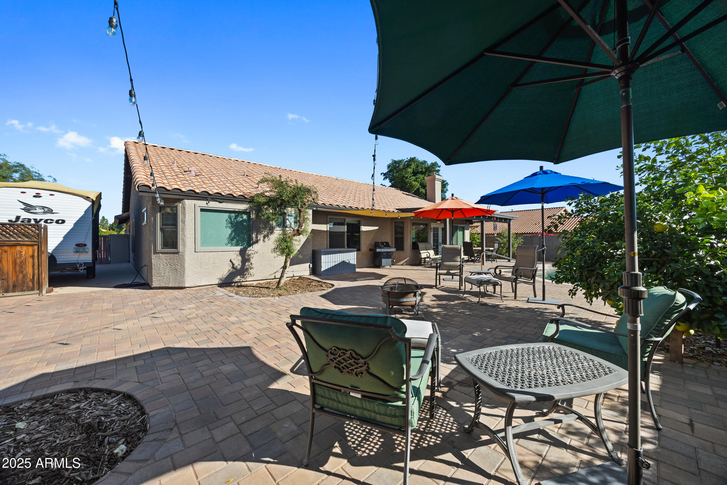 1111 West Lisa Lane Tempe, AZ 85284 - Photo 39 of 58 a patio with a table and chairs under an umbrella