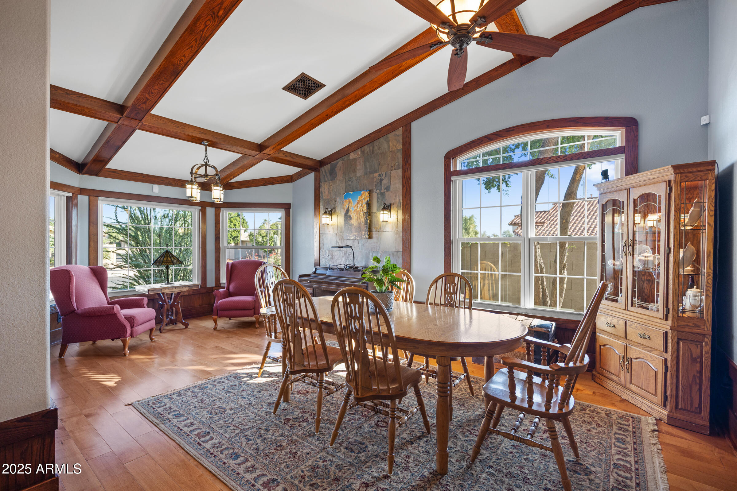 1111 West Lisa Lane Tempe, AZ 85284 - Photo 7 of 58 a dining room with furniture a chandelier and wooden floor