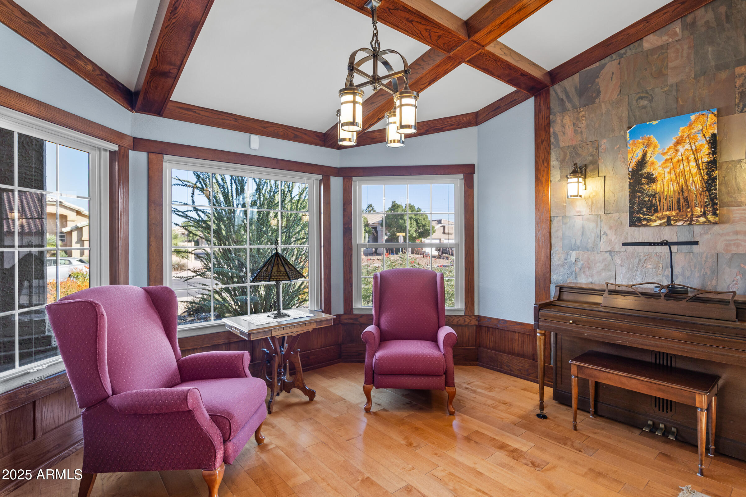 1111 West Lisa Lane Tempe, AZ 85284 - Photo 8 of 58 a living room with furniture a fireplace and a chandelier