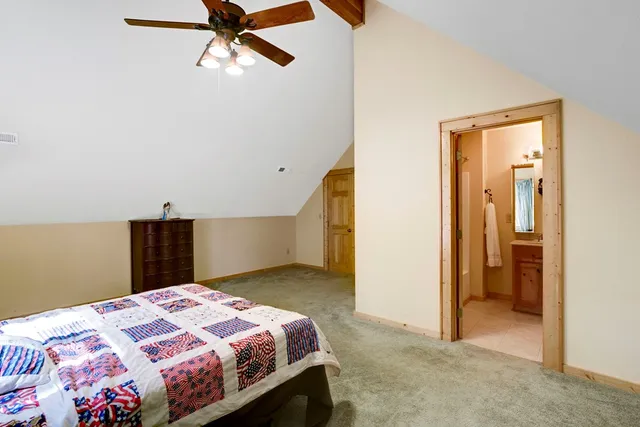 a bedroom with a bed and a painting on the wall