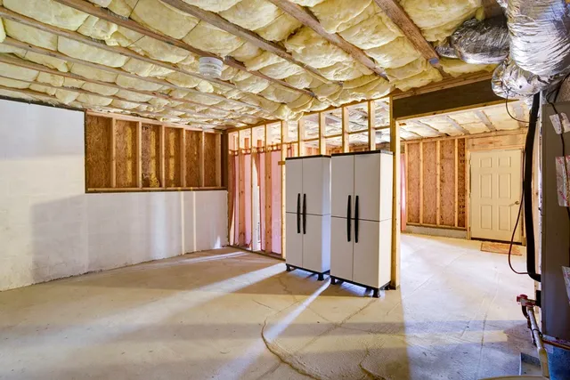 a kitchen with a table chairs sink and cabinets