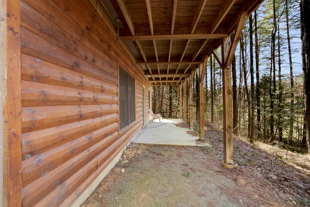 a view of a barn house with a large tree