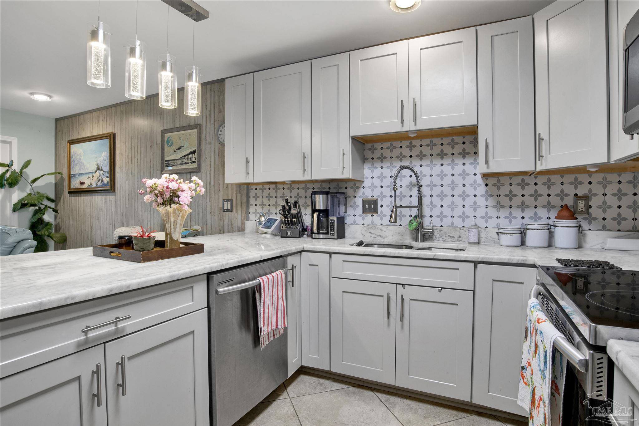 13351 Johnson Beach Road, Unit 203E Perdido Key, FL 32507 - Photo 11 of 55 a kitchen with cabinets and white stainless steel appliances