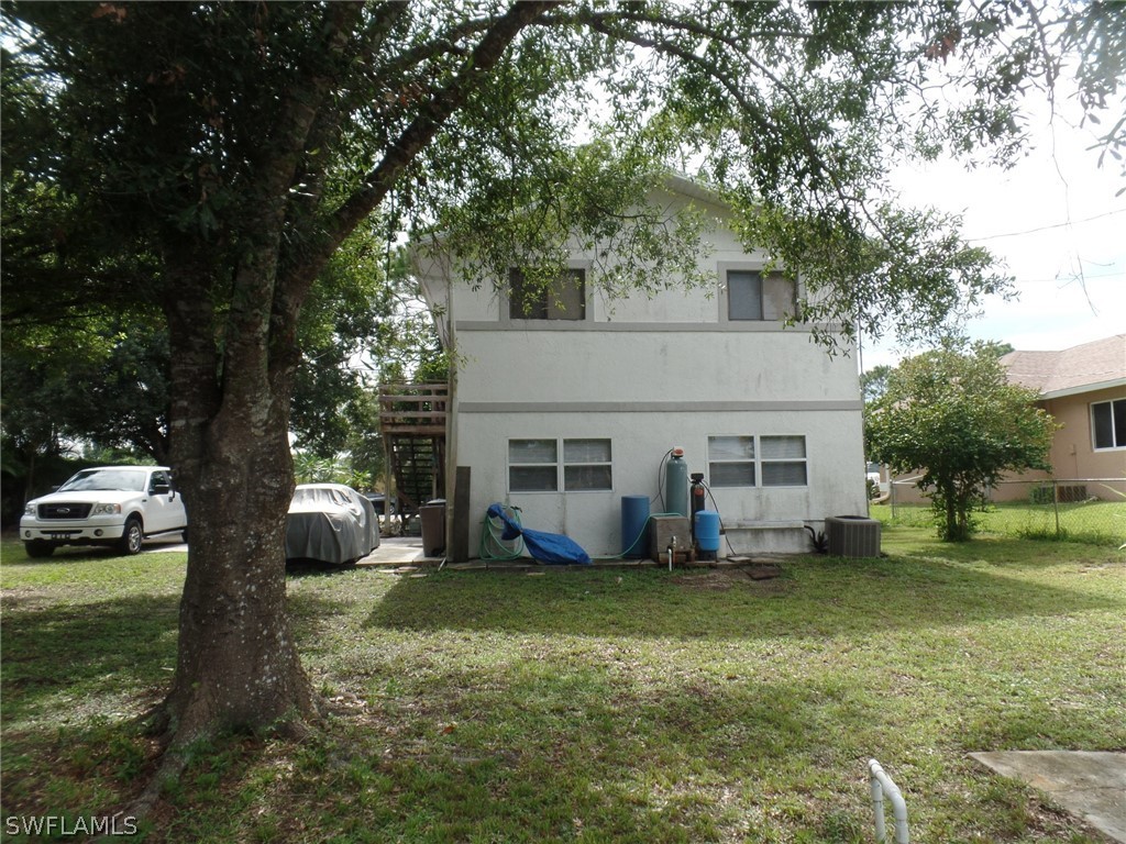 18275 Useppa Road Fort Myers, FL 33967 - Photo 3 of 8 a view of a house with a yard patio and fire pit