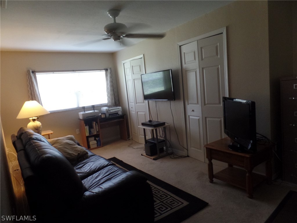 18275 Useppa Road Fort Myers, FL 33967 - Photo 6 of 8 a living room with furniture a window and a flat screen tv