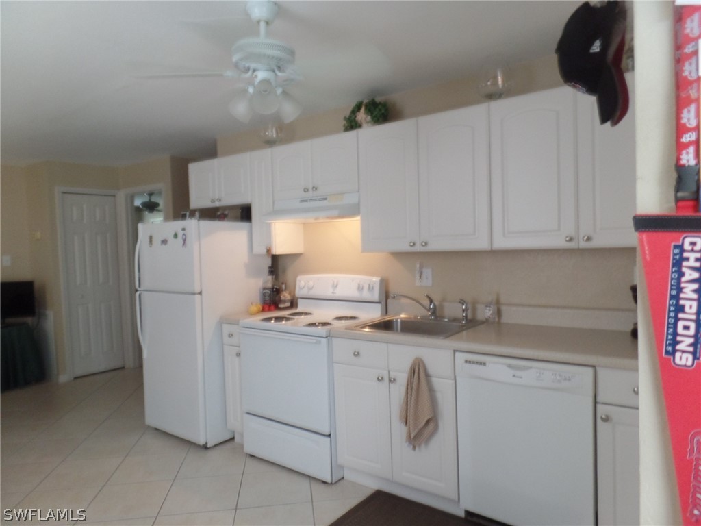 18275 Useppa Road Fort Myers, FL 33967 - Photo 7 of 8 a kitchen with a sink a refrigerator and cabinets